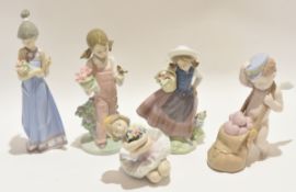 Group of Lladro porcelain children in various poses, largest 21cm high