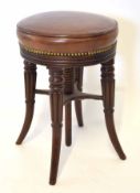 Victorian circular adjustable piano stool raised on four splayed carved and ring turned supports,