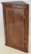 Late 18th century mahogany corner cupboard, cross banded door enclosing an interior of fitted shaped