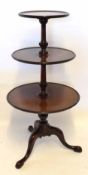 19th century mahogany three tier circular pedestal dumb waiter, tripod base with hoof feet, 123cm