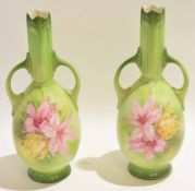 Pair of late 19th century Continental vases decorated with floral sprays on a green ground, the