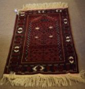 Caucasian prayer rug, central panel of geometric designs, mainly red field throughout, 112 x 79cm