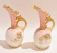 Pair of late 19th century Doulton Burslem ewers with a floral design and dragon style handle, 22cm