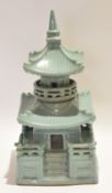 Oriental pottery model of a temple or pagoda in a green glaze with detachable top, 39cm high