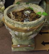 Weathered cement garden urn of tapering circular form moulded with figures etc, 54cm high