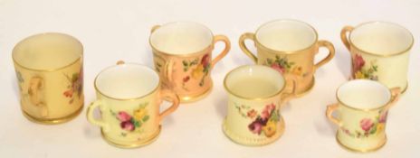 Collection of Royal Worcester miniature tygs and mugs all decorated with flowers on a blush