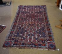 NE Persian Kurd wool carpet, triple gull border, central panel of interlinked geometric lozenges,