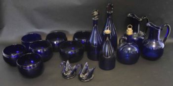 Quantity of Bristol Blue glass comprising two decanters with faceted stoppers, two water jugs, two