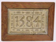 Vintage plaster plaque bearing date 1584 (damaged) in a pine frame, 24cm wide