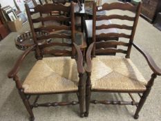 PAIR OF OAK FRAMED LADDERBACK ARMCHAIRS WITH RUSH SEATS