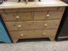 WAXED PINE FRAMED TWO OVER TWO FULL WIDTH DRAWER CHEST WITH TURNED KNOB HANDLES