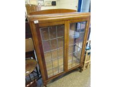 WALNUT FRAMED BOOKCASE WITH TWO LEADED AND GLAZED DOORS ON PAD FEET