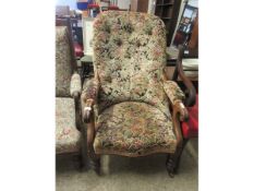 VICTORIAN FLORAL COVERED ARMCHAIR ON TURNED FRONT LEGS AND PORCELAIN CASTERS