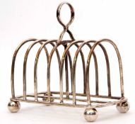 George V six-slice toast rack, the arched wire work frame to a rectangular base raised on four