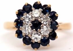 Diamond and sapphire cluster ring, claw set and raised in a basket mount, stamped 750, size K/L
