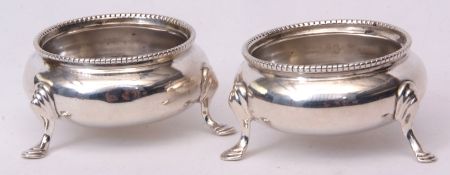 Two Victorian cauldron salts, each of polished form with beaded rims on three cast and applied feet,