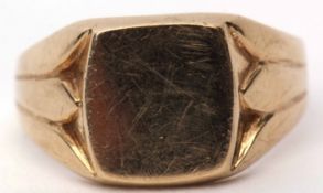 9ct gold gent's signet ring, the shaped square plain panel, between carved shoulders to a plain