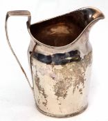 George III milk jug of plain polished helmet form with reeded rim and strapwork handle (repaired),