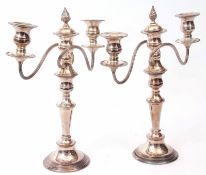Two late 20th century electro-plated three light candelabra, each with detachable nozzles and urn