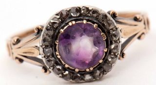 Antique diamond and purple stone ring, the centre a circular shaped purple stone within a surround