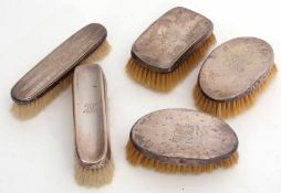Mixed Lot: comprising two silver backed oval hair brushes together with a further single hair