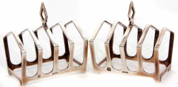 Two George V Art Deco style four-slice toast racks, each of angular strapwork form with central