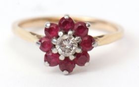 Precious metal diamond and ruby cluster ring, the central brilliant cut diamond (0.15ct approx)