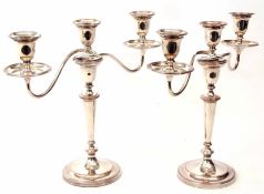 Pair of early 20th century silver on copper three-light candelabra, each with detachable drip pans
