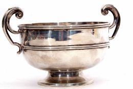 Edward VII two-handled bowl of polished circular form with girdled body and flying C-scroll