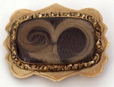 Victorian gilt metal memoriam brooch of shaped rectangular design with a framed glazed plaited