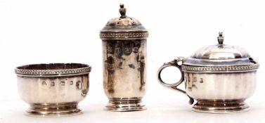 George V three piece cruet set comprising pepper caster, lidded mustard and open salt, each of