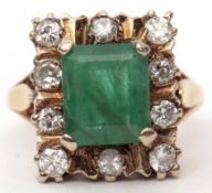 Emerald and diamond cluster ring, the oblong shaped emerald 8.6mm, within a surround of ten small