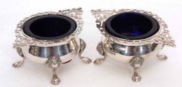 Two Edward VII open salts each with pierced and applied rims to polished bodies and raised on four