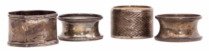 Mixed Lot: comprising four various napkin rings, one with ivory insert, weighable silver approx