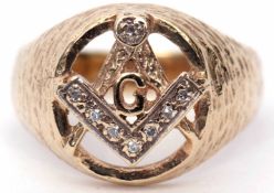 9ct gold and diamond Masonic ring, the oval pierced panel with a compass and ruler motif,