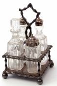 Late 19th century Britannia metal four-bottle cruet stand of square form with central handle (handle