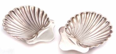 Two Edward VII shell butter dishes of typical form, each raised on three ball feet, length 10 1/2cm,