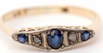 Precious metal Art Deco style sapphire and diamond ring having an oval cut centre sapphire between