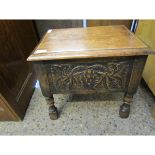 EARLY 20TH CENTURY OAK FRAMED LIFT UP TOP SEWING BOX WITH CARVED PANELS