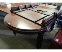 REPRODUCTION MAHOGANY REGENCY TYPE EXTENDING DINING TABLE WITH REEDED LEGS RAISED ON BRASS CASTERS