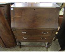 OAK FRAMED DROP FRONTED BUREAU FITTED WITH TWO DRAWERS ON A TURNED BASE