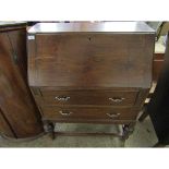 OAK FRAMED DROP FRONTED BUREAU FITTED WITH TWO DRAWERS ON A TURNED BASE