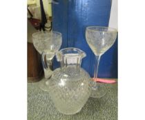 CUT GLASS WATER JUG TOGETHER WITH TWO WINE GLASSES WITH ENGRAVED DESIGN, TALLEST 19CM