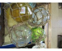 FOUR GLASS BALLS IN NETTING