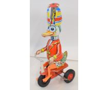 Late tinplate of a circus Duck riding a tricycle. Height approx 8"