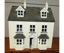 Modern wooden doll’s house with hinged front walls and roof, together with a quantity of various