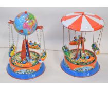 A pair of modern tinplate model Carousels, each approximately 8"