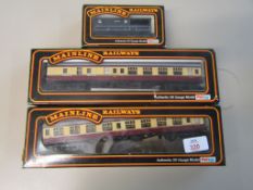 Three boxed Mainline 00 gauge rolling stock comprising two BR cream and crimson coaches and a GWR