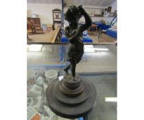 METAL MODEL OF A PUTTI ON A CIRCULAR STEPPED PLINTH