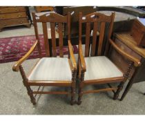 PAIR OF MID-20TH CENTURY OAK FRAMED ARMCHAIRS WITH CREAM DROP IN SEATS ON BOBBIN TURNED SUPPORTS